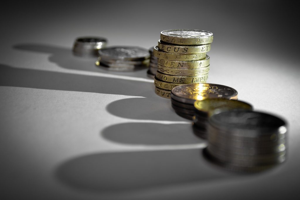 Pound coins stacked next to each other